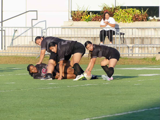 Taken at a Rugby game on Speer’s field, Alondra Zamudio is seen on the far right with her teammates mid game. In the image, Zamudio is grabbing the rugby ball while looking back at players on the opposing team to pass it onto her teammates on the left.
